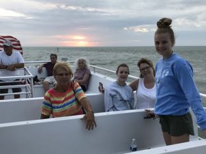 family in a boat at sunset 