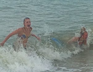 two girls splashing and playing in the water