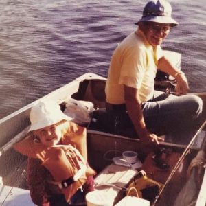 old photo of a father and child in a boat on the lake