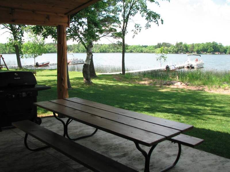 The covered patio offers a sheltered lakeview.